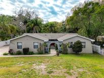 Charming single-story home with a well-manicured lawn and mature trees at 5005 Puritan Rd, Tampa, FL 33617
