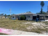 Single story home featuring a screen lanai and drought tolerant landscaping at 6411 26Th W St, Bradenton, FL 34207