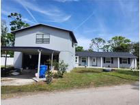 Charming two-story home features a carport and a well-maintained front yard at 9950 Morris Bridge, Tampa, FL 33637