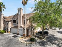Charming townhome features a tile roof, an attached garage, and well-maintained landscaping at 10434 Villa View Cir, Tampa, FL 33647