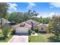 Charming single-story home featuring an attached two-car garage and manicured front lawn at 10509 Deepbrook Dr, Riverview, FL 33569