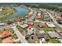 An aerial view of the neighborhood shows homes with mature landscaping, and close proximity to a large lake at 2004 Berry Roberts Dr, Sun City Center, FL 33573