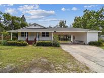Charming home featuring a covered carport, and well-maintained lawn and landscaping at 2231 Nichols Rd, Lithia, FL 33547