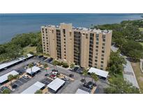 Condominium building showing parking spaces with covered parking with view of the Bay and bridge at 2616 Cove Cay Dr # 803, Clearwater, FL 33760