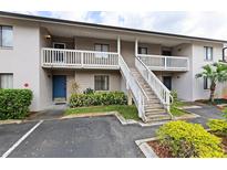 A multi-story condo building with exterior stairs and well-maintained landscaping at 3706 Greenery Ct # 206, Tampa, FL 33618