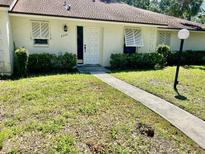 Charming single-story home featuring a well-kept lawn and a welcoming front entrance with classic white door and shutter accents at 5340 Royal Palm Ave # 5340, Sarasota, FL 34234