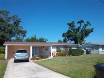 Charming single-story home with well-manicured lawn and colorful accents at 5413 S Martin Ave, Tampa, FL 33611