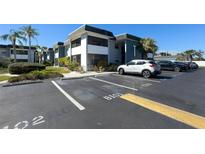 Condominium featuring screened balconies, well-maintained landscaping, and plenty of parking spaces at 5509 Fountain Lake Cir # C209, Bradenton, FL 34207