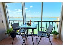 Relax on the balcony with waterfront views and seating for two at 7700 Sun Island S Dr # 506, South Pasadena, FL 33707