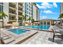 Beautiful community pool and spa area with lounge seating and lush landscaping at 1238 E Kennedy Blvd # 702, Tampa, FL 33602