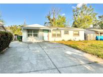 Charming single-story home featuring a well-maintained front yard and a welcoming entrance with a quaint, colored door at 13649 120Th St, Largo, FL 33778