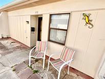 Inviting home exterior showcasing a cozy patio area with chairs and decorative accents at 1473 Feather Dr # 1473, Clearwater, FL 33759