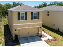 Charming two-story home with a two-car garage and well-manicured landscaping at 16810 Trite Bend St, Wimauma, FL 33598