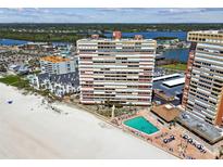 Expansive aerial view of the condominium building with a swimming pool and beach access at 17940 Gulf Blvd # 9B, Redington Shores, FL 33708