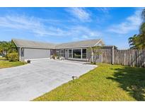 Charming single Gathering home featuring a well-manicured lawn and a freshly painted gray exterior at 2924 Catherine Dr, Clearwater, FL 33759