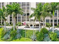 Beautifully landscaped Monte Carlo Towers with palm trees, lush greenery, and a welcoming entrance at 3301 Bayshore Blvd # 2401E, Tampa, FL 33629