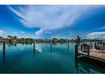 Beautiful waterfront view with dock and bright blue skies, offering a serene and picturesque setting at 333 Island Way # 203, Clearwater Beach, FL 33767