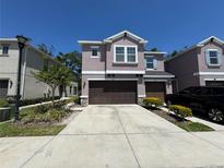Charming two-story townhome with a two-car garage and well-maintained landscaping at 6617 Citrus Creek Ln, Tampa, FL 33625