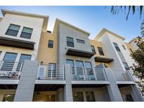 Modern townhome featuring a private balcony, clean lines, and neutral color palette, bathed in the warm sunlight of a clear blue sky at 1182 25Th N Way, St Petersburg, FL 33713