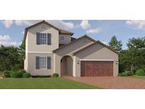 Charming two-story home featuring a brick driveway, a two-car garage, and well-maintained landscaping at 11829 Sparkling Topaz Cv, Parrish, FL 34219