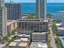 An aerial view of the surrounding buildings and street including the large blue ocean at 175 2Nd S St # 907, St Petersburg, FL 33701