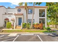 Charming two-story condo featuring lush landscaping, a private entrance, and ample parking at 476 Santa Cruz Ne Pl # C, St Petersburg, FL 33703