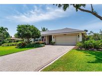 Beautiful single-story home featuring brick driveway, attached garage, and well-manicured landscaping at 500 Tallahassee Ne Dr, St Petersburg, FL 33702
