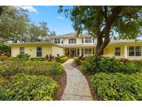 Charming two-story home with mature landscaping and a welcoming walkway to the front door at 5902 Audubon Manor Blvd, Lithia, FL 33547