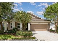 Charming single-story home with a well-manicured front yard and two-car garage at 6524 Park Strand Dr, Apollo Beach, FL 33572