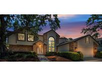 Charming home featuring a well-manicured lawn, brick accents, and a large window at 962 Marco Ne Dr, St Petersburg, FL 33702