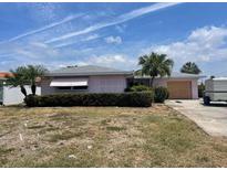 Charming single-story home with mature landscaping and a covered front window at 11365 4Th E St, Treasure Island, FL 33706