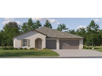 Charming single-story home with a neutral color palette, two-car garage, and a well-manicured lawn at 15263 Rainbow Quartz St, Wimauma, FL 33598