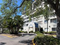 Beautiful condominium building with tropical landscaping and covered entrance for easy access to the property at 2333 Feather Sound Dr # B104, Clearwater, FL 33762