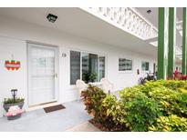 Charming condo entrance with a cozy patio area and view of the well-maintained exterior at 2469 Franciscan Dr # 19, Clearwater, FL 33763
