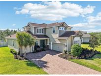 Stunning two-story home featuring a paver driveway and beautiful landscaping at 3952 Bonfire Dr, Odessa, FL 33556