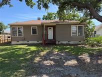 Charming single-story home featuring a cozy front porch and a well-maintained front yard under a shady tree at 536 89Th N Ave, St Petersburg, FL 33702