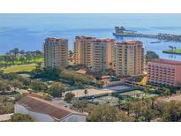 Stunning aerial view of a high-rise waterfront condo featuring tennis courts and bay access at 555 5Th Ne Ave # 424, St Petersburg, FL 33701