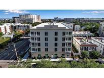 Modern condo building featuring a neutral color palette, multiple balconies, and well-maintained landscaping at 600 3Rd S Ave # 201, St Petersburg, FL 33701