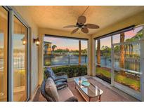 Relaxing screened porch with ceiling fan overlooking tranquil pond with fountain at 600 Gardens Edge Dr # 614, Venice, FL 34285