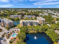 Aerial view of resort condos, showcasing a pool, lake with fountain and manicured landscaping at 960 Starkey Rd # 1503, Largo, FL 33771