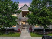Charming two-story condo building featuring manicured landscaping and stone accents for a welcoming curb appeal at 1231 Godavari Way # 103, Wesley Chapel, FL 33543