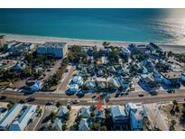 Charming neighborhood with beach access, showcasing a mix of homes and vibrant blue ocean views at 12409 Gulf Blvd, Treasure Island, FL 33706
