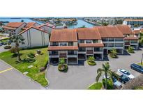 Beautiful condo building showcasing the classic architecture and well-manicured landscaping at 126 1St E St # 102, Tierra Verde, FL 33715
