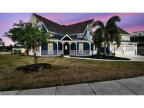 Charming blue Victorian home with a white picket fence and lush landscaping at 1500 Elmwood St, Clearwater, FL 33755