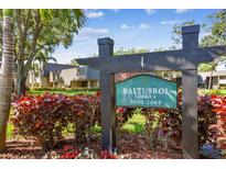 Baltusrol Lodge 4 signage, nestled within lush landscaping and mature trees on a sunny day at 36750 Us 19 N # 06111, Palm Harbor, FL 34684