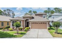 Charming two-story home with a well-maintained lawn and two car garage at 7815 Blue Spring Dr, Land O Lakes, FL 34637