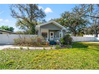 Charming craftsman home featuring a well-manicured front yard and inviting entryway at 905 E Hanna Ave, Tampa, FL 33604