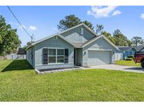Charming single-story home with a well-maintained lawn and gray exterior paint at 10463 Baylor Dr, Spring Hill, FL 34608