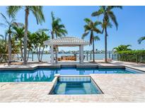 Beautiful waterfront home featuring a pool, spa, cabana, and dock with incredible water views at 16353 Redington Dr, Redington Beach, FL 33708