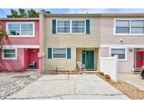Charming townhouse featuring colorful exteriors, green shutters, and a welcoming front porch at 2811 S Pines Dr # 15, Largo, FL 33771